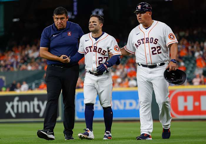 An injured Jose Altuve walks off the field.
